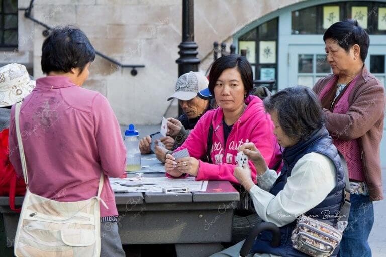 Elderly women playing card games outside in Chinatown, New York