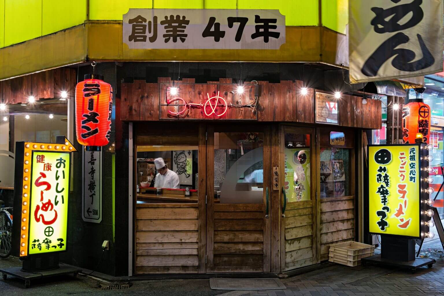 Japanese restaurant with neon advertising and lanterns in Dotonbori, Minami, Osaka, Japan