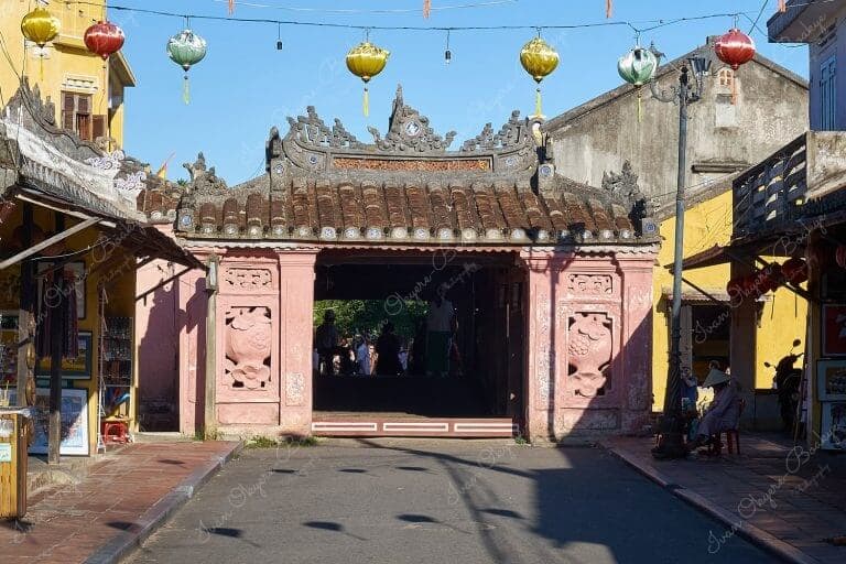 The pastel pink walled entrance to the Japanese Covered Bridge (Cau Nhat Ban) from Tran Phu in Hoi An Old Town, Vietnam