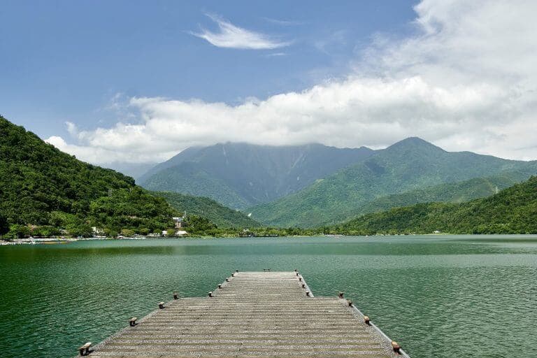 Empty pier leading towards the view of the lake and mountains at Carp Lake, Taiwan