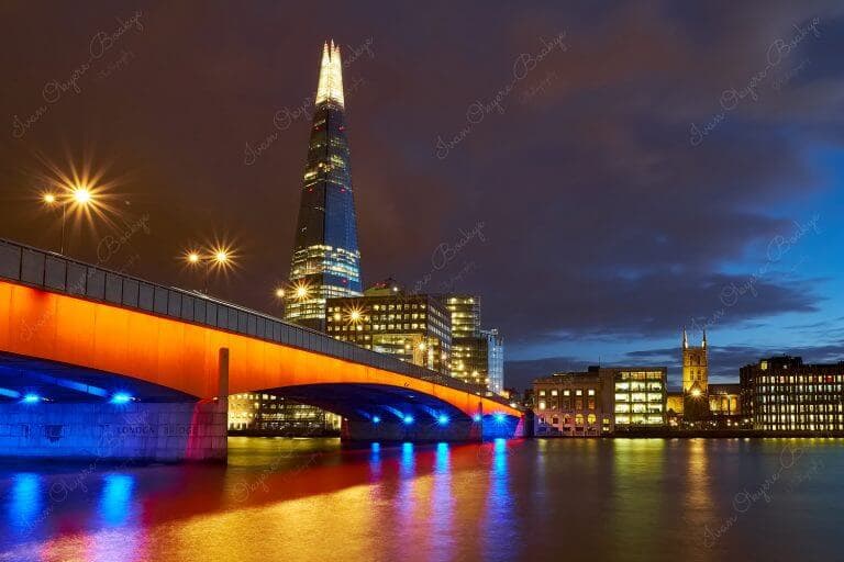 An illuminated London Bridge and The Shard at night, London, United Kingdom
