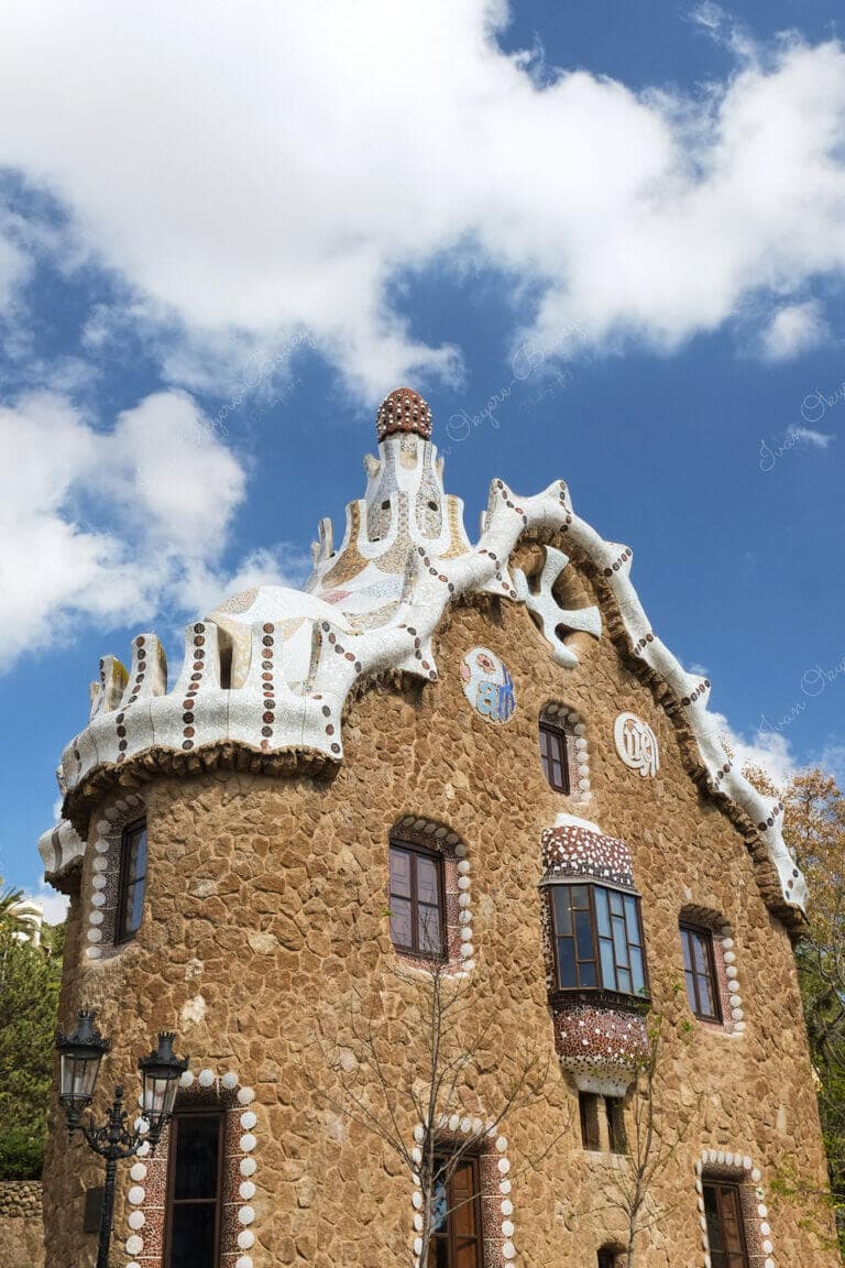 Porter's Lodge pavilion (Casa del Guarda) with tile shard mosaic roof at main entrance of Park Güell, Barcelona, Spain