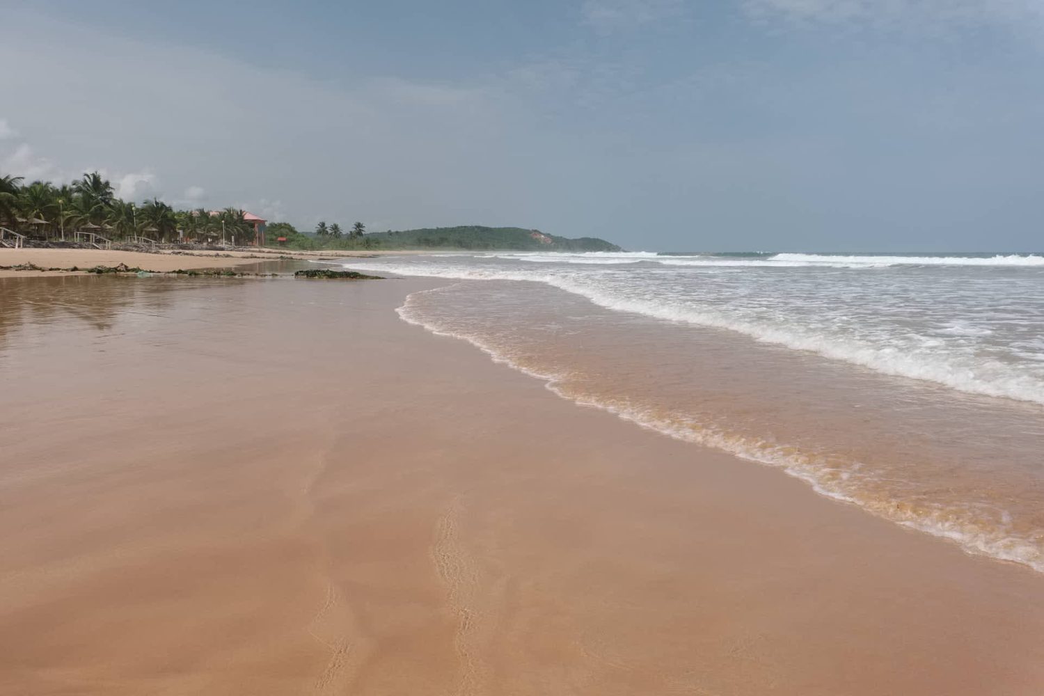 Deserted golden sandy beach at Busua Beach in Ghana