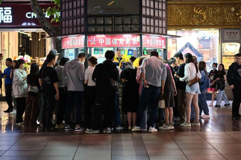 Shoppers crowded round market stall in Nanjing Road, Shanghai, China