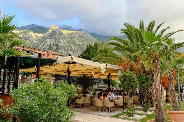 People relaxing and enjoying drinks in restaurant along the Kotor Bay Promenade, Kotor, Montenegro