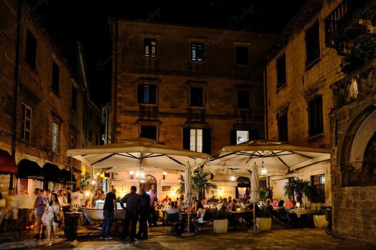 People enjoying al fresco evening dining in restaurant in the Old Town, Kotor, Montenegro