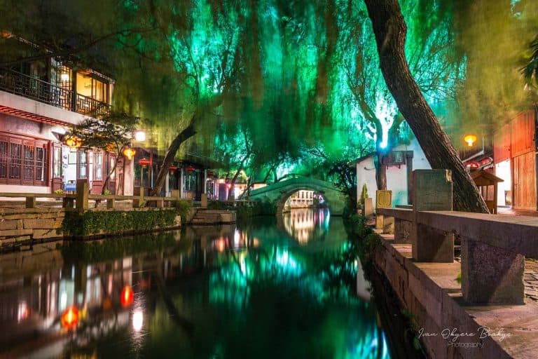 Illuminated canal and buildings at night, Zhouzhuang Water Town, China