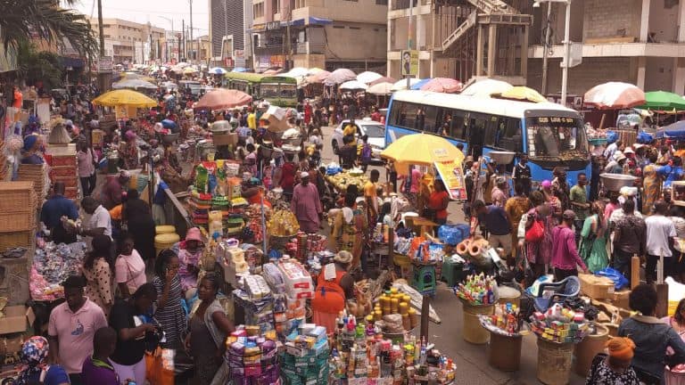 Aerial video view of busy crowded Makola market street, Accra, Ghana,
