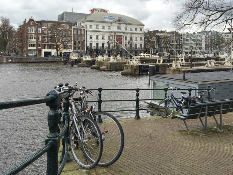 Vew of bicycles chained to waterfront railings, Amsterdam, Netherlands