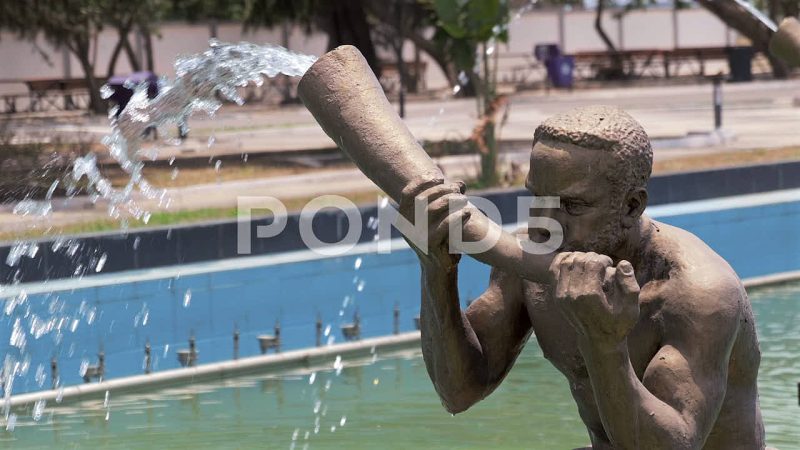 Isolated View Of Flute Player Water Fountain Sculpture, Accra, Ghana Isolated View Of Flute Player Water Fountain Sculpture, Accra, Ghana