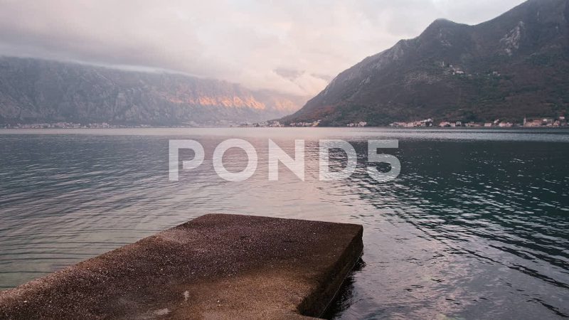 Empty Stone Pier At Perast Beach Facing Kotor Bay, Perast, Montenegro Empty Stone Pier At Perast Beach Facing Kotor Bay, Perast, Montenegro