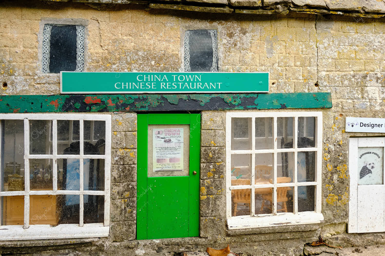 Elevated standing view of a miniature replica traditional English stone house Chinese restaurant in Bourton on the Water Model Village, England, UK