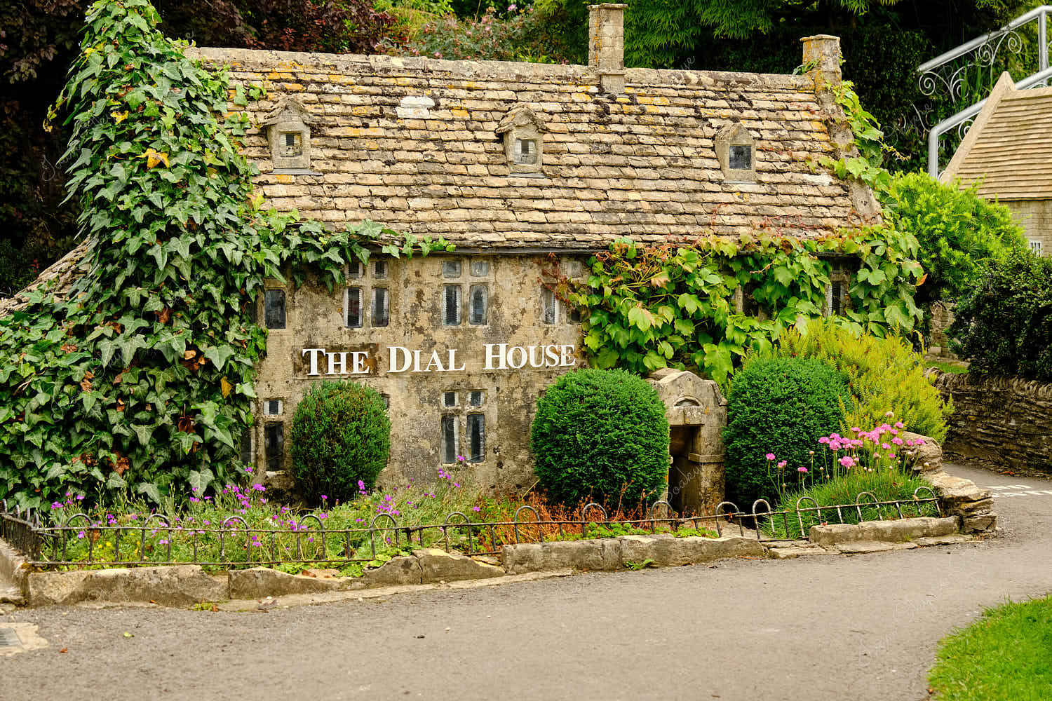 Elevated standing view of a miniature replica traditional English stone house hotel in Bourton on the Water Model Village, England, UK