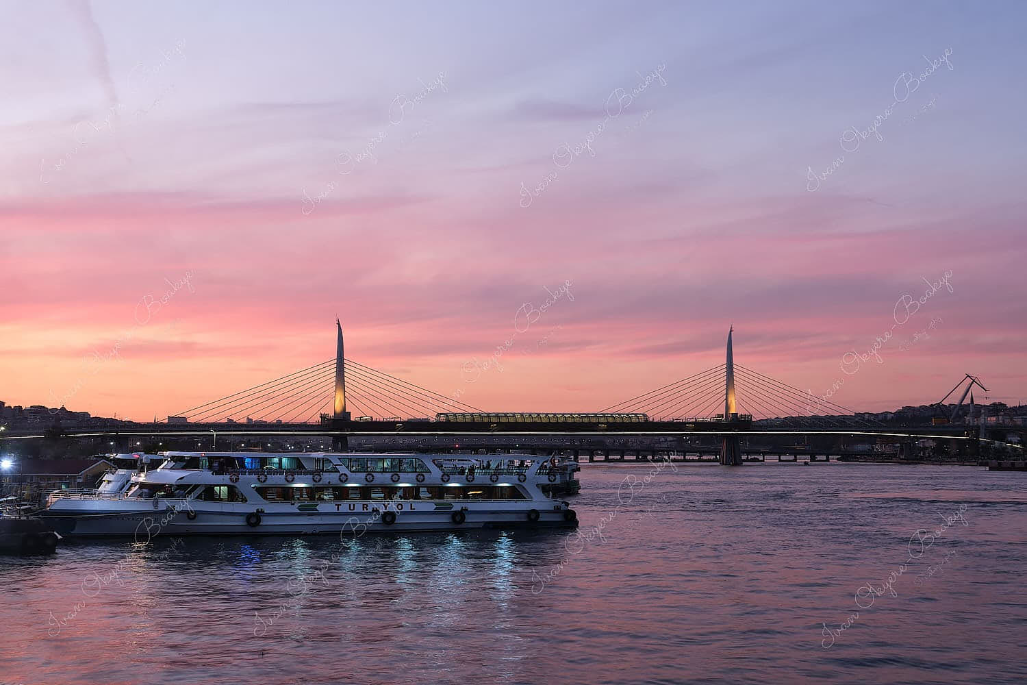 Moored Turyol ferry boats on the Bosphorus river at sunset with the Golden Horn Metro Bridge in the background, Istanbul, Turkey
