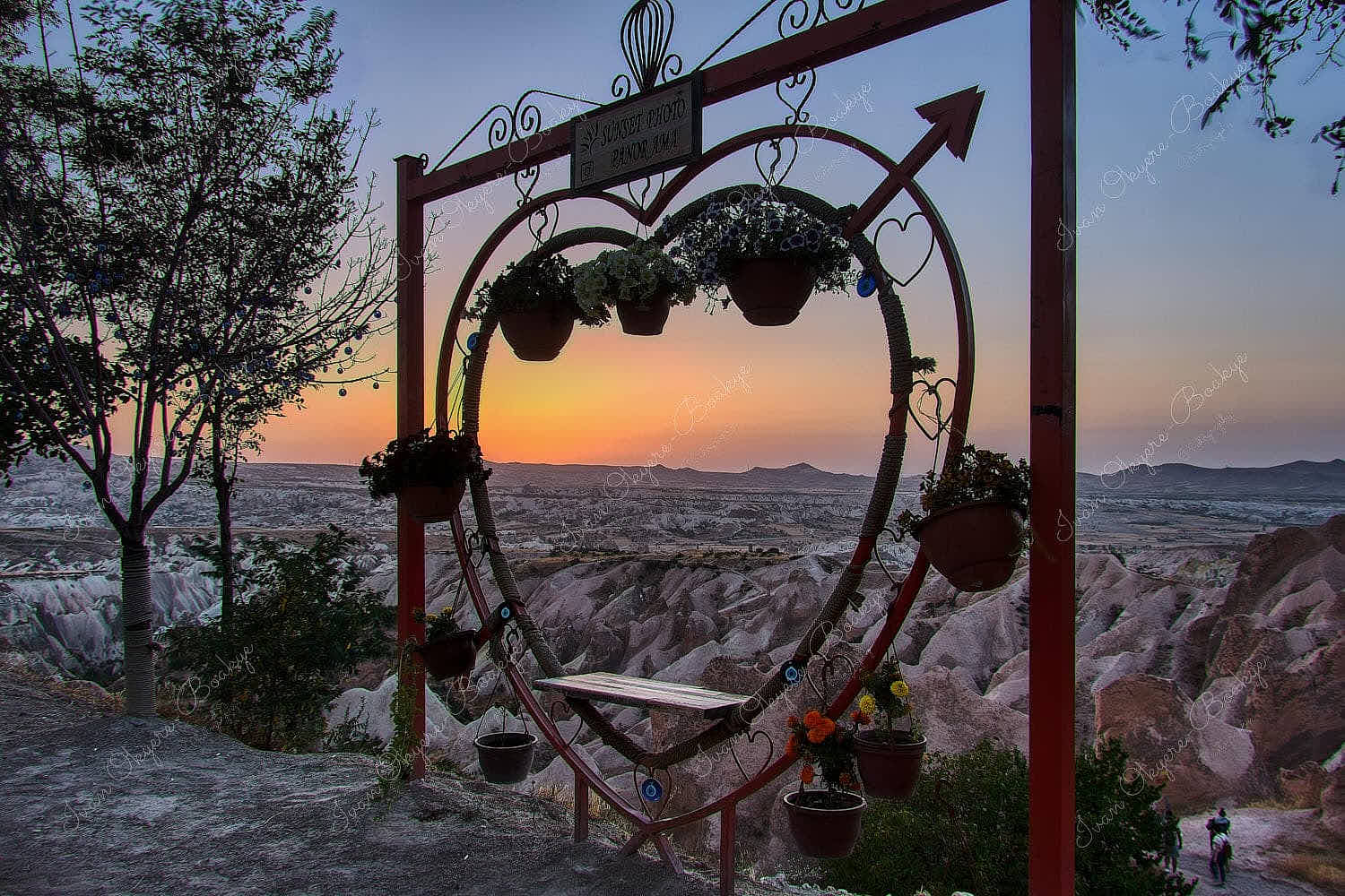 Sunset view through a love heart seat of the Cappadocia rock formations landscape from the Red Valley Panorama Lookout, Cappadocia, Turkey