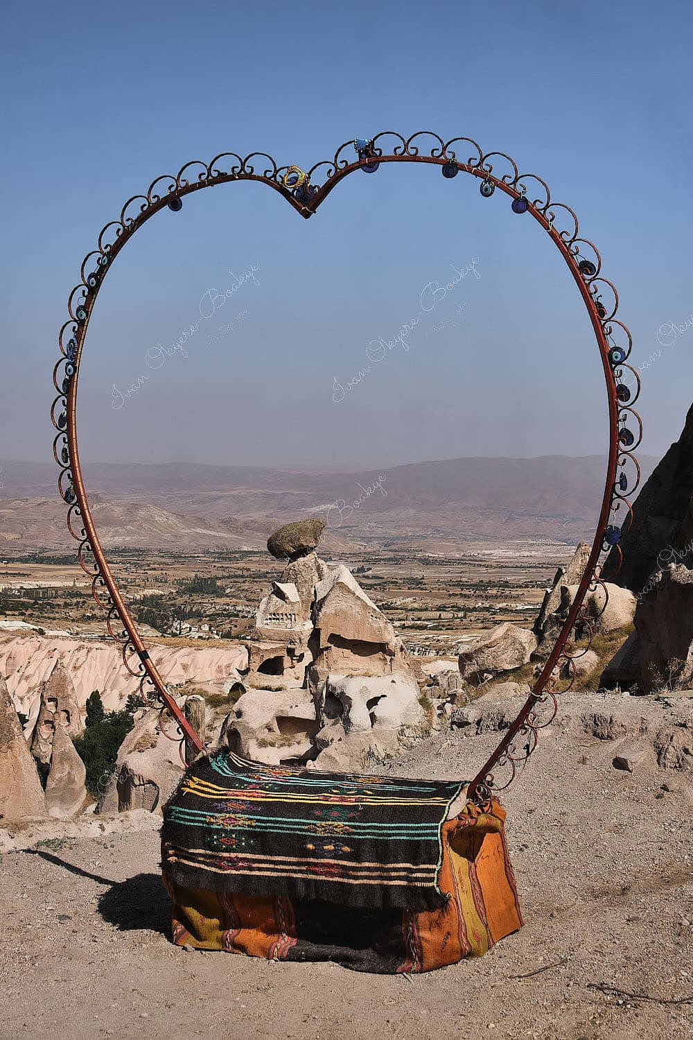 Love heart seat overlooking the fairy chimney rock formations landscape at Uchisar Castle, Cappadocia, Turkey
