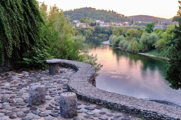 View of the Ribnica River and town from a tree lined bank path, Podgorica, Montenegro