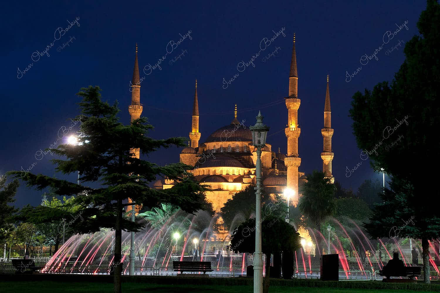 The illuminated coloured Sultanahmet Park Fountain with the majestic Blue Mosque in the background, Istanbul, Turkey