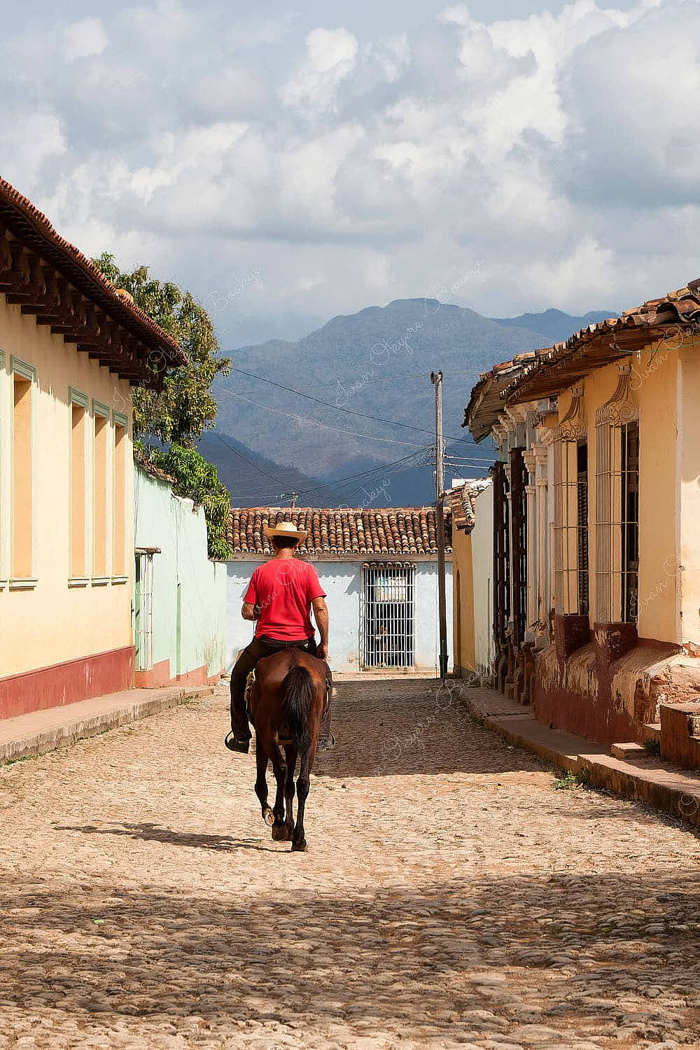 Cuban man riding a horse in the streets in Trinidad, Cuba