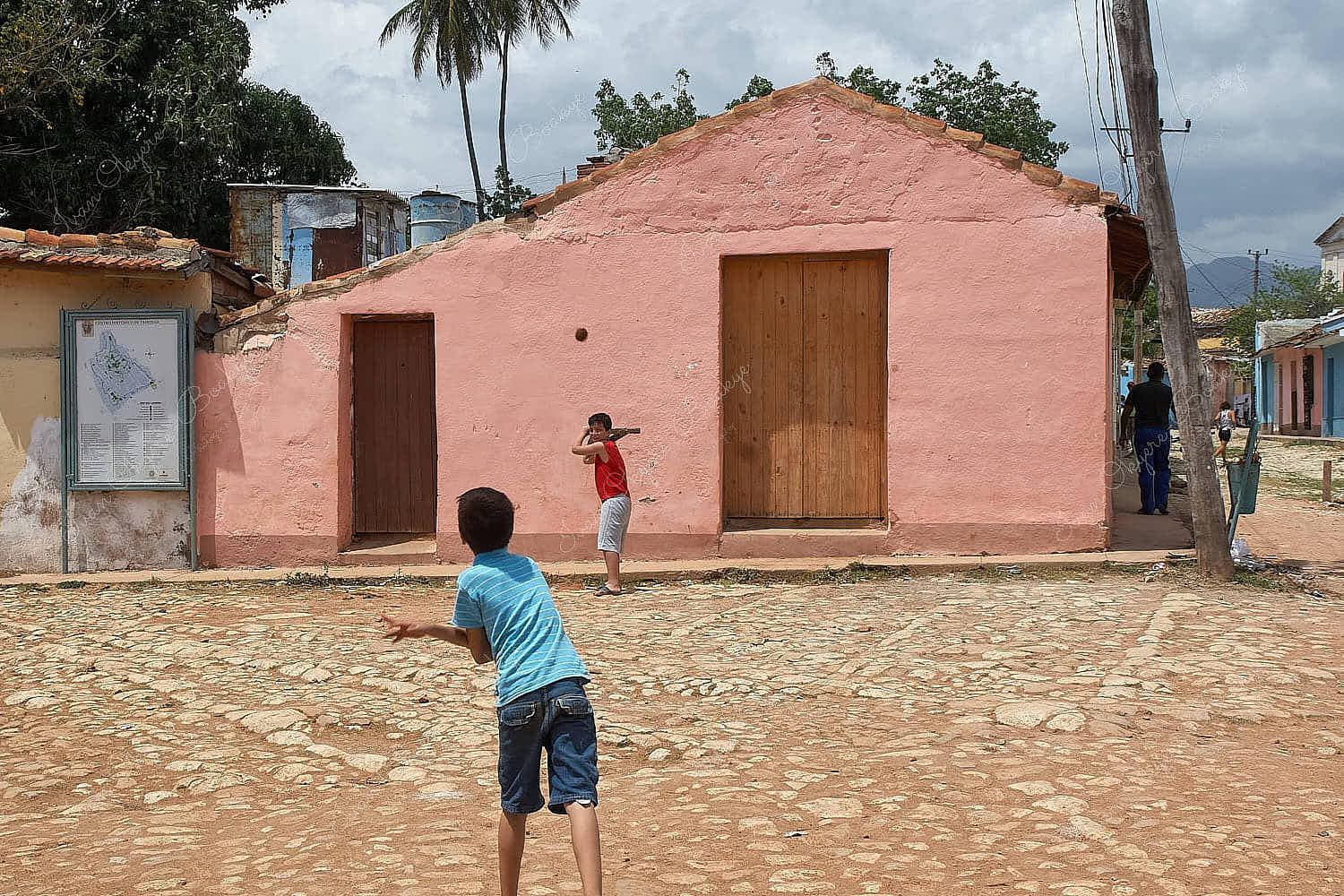 Boys playing baseball in the streets in Trinidad, Cuba