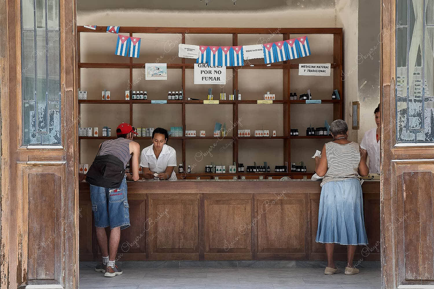 Cuban customers buying medicines in a pharmacy store selling traditional nautral medicines in Havana Vieja, Cuba