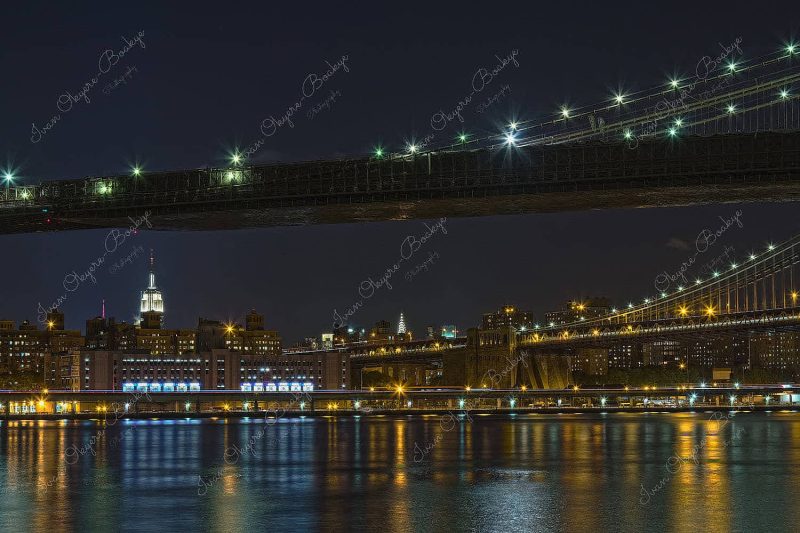Night view of Brooklyn Bridge the Empire State Building and Manhattan Bridge, New York, America