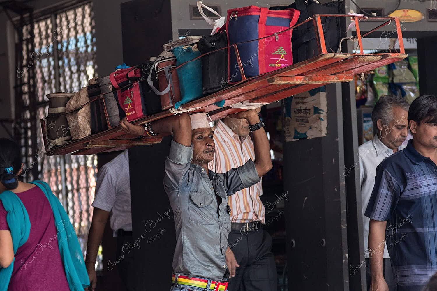 Dabbawala carrying Lunch Dabbas (Tiffin Boxes) for delivery to customers outside Churchgate Railway Station in Mumbai, India