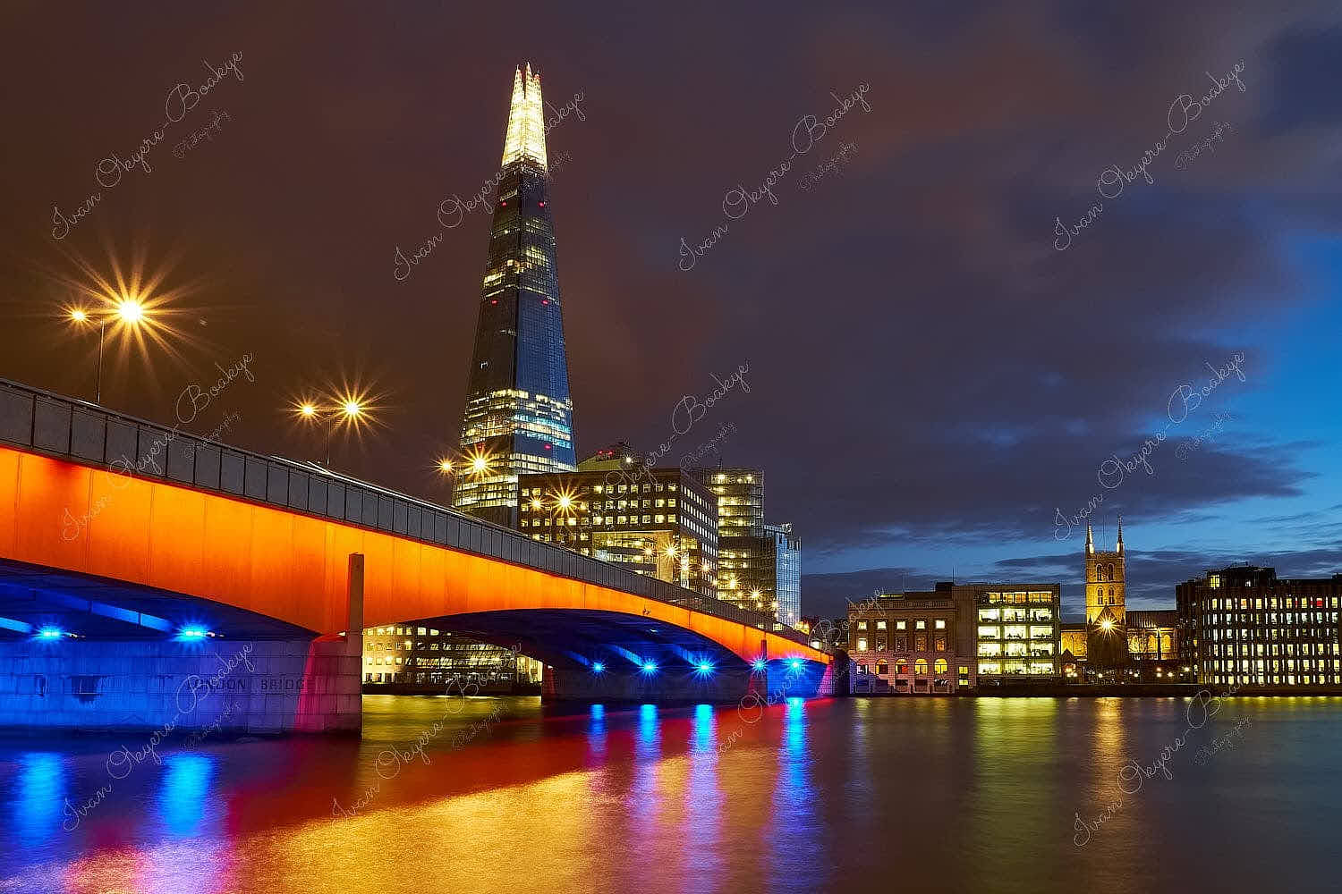 An illuminated London Bridge and The Shard at night, London, United Kingdom