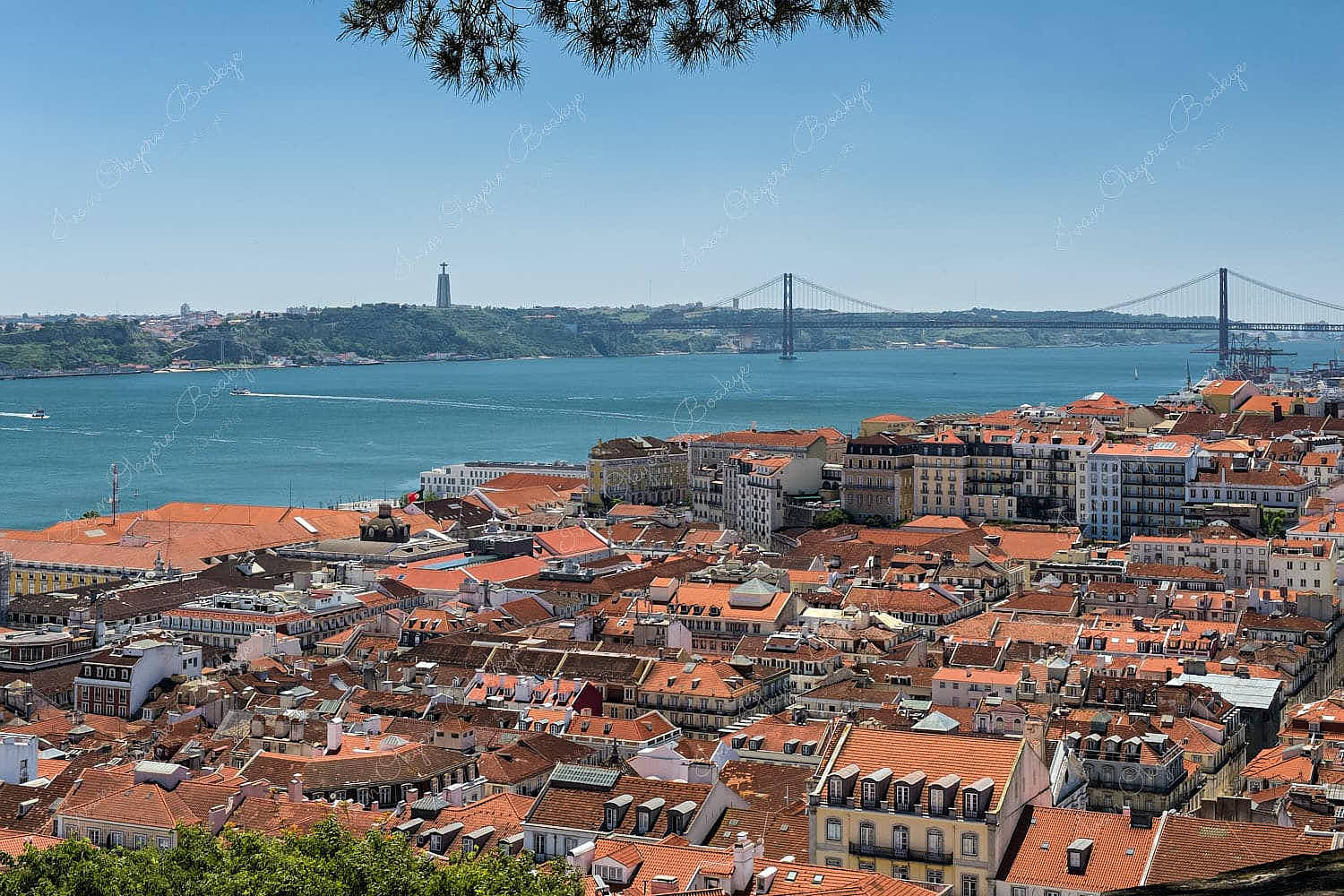 View of Cristo Rei statue and Ponte 25 de Abril in Alfama, Lisbon, Portugal