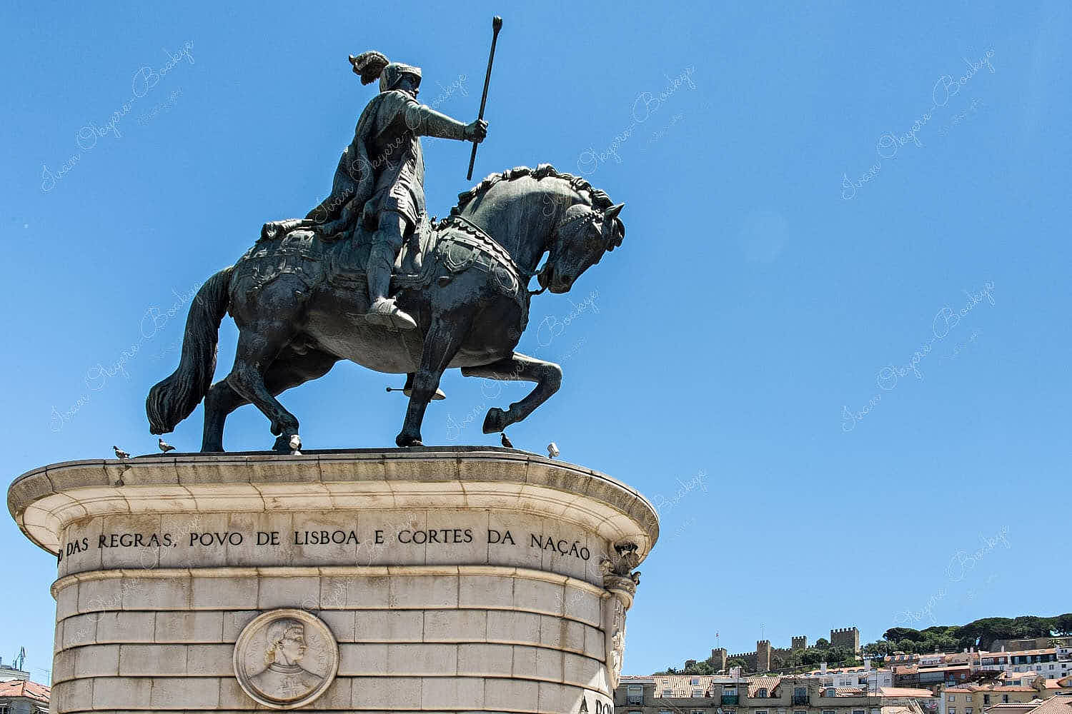 Statue of Dom João I with Castelo de Sao Jorge in background in Alfama, Lisbon, Portugal
