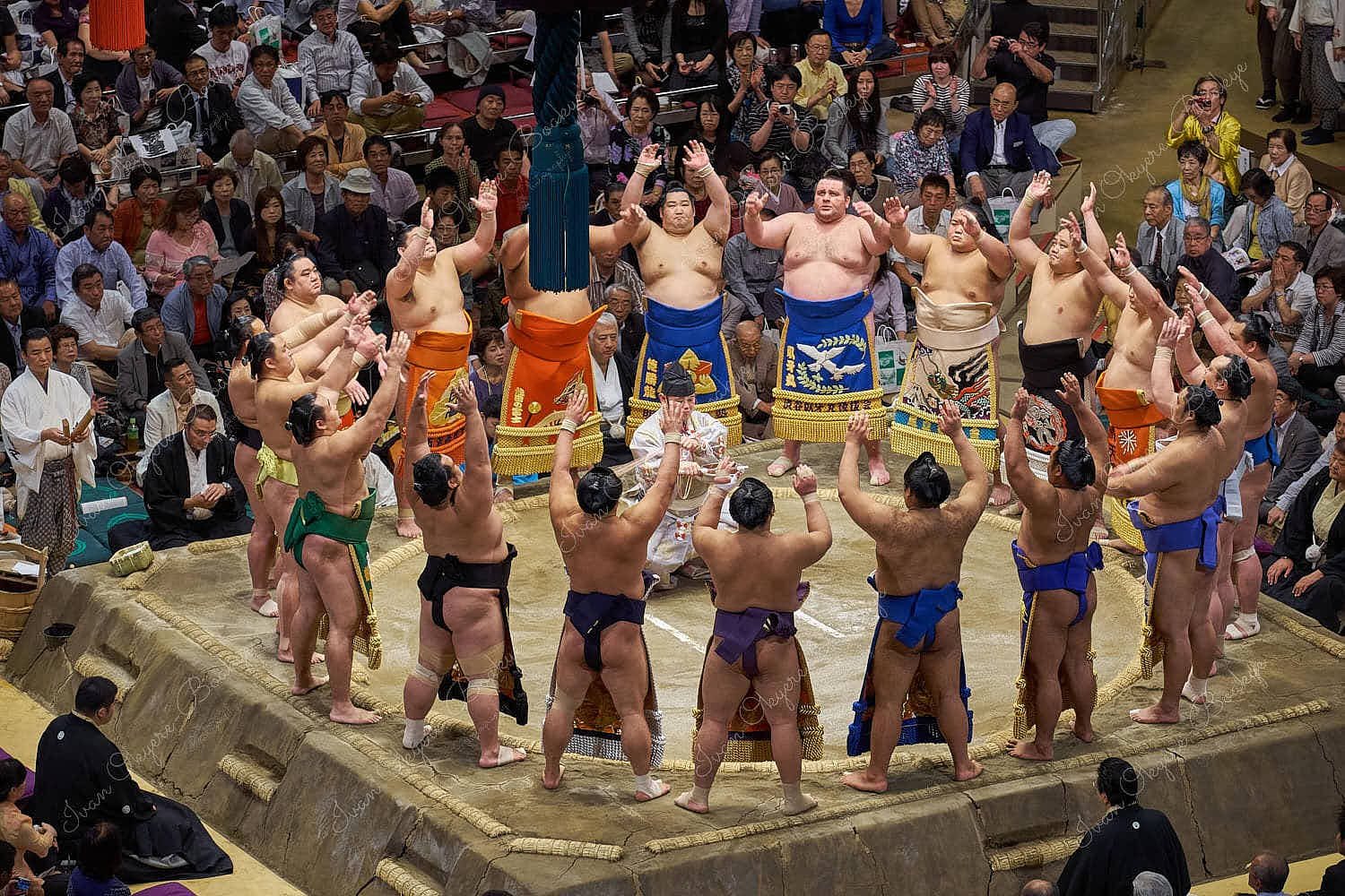 Sumo wrestlers in sumo wrestling ring for closing ceremony tradition at 2013 September Grand Sumo Tournament at the Ryogoku Kokugikan, Tokyo, Japan