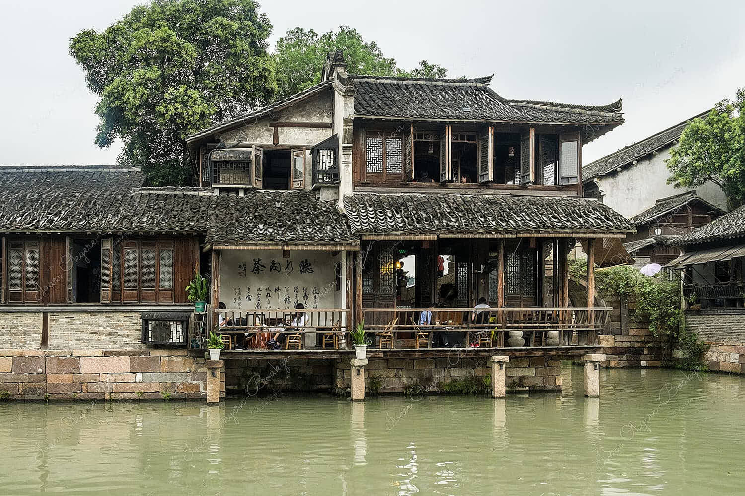 Traditional Chinese restaurant on the corner of a canal in the historic scenic Wuzhen water town, Xizha, China