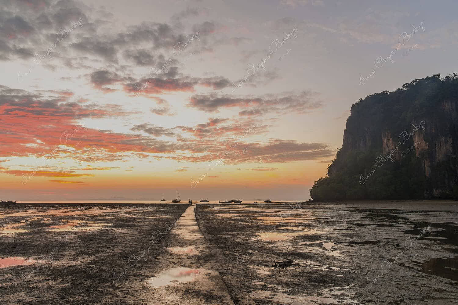 The dramatic gritty sandy landscape of Hat Rai Leh East beach at low tide at sunrise, Railey Bay, Thailand