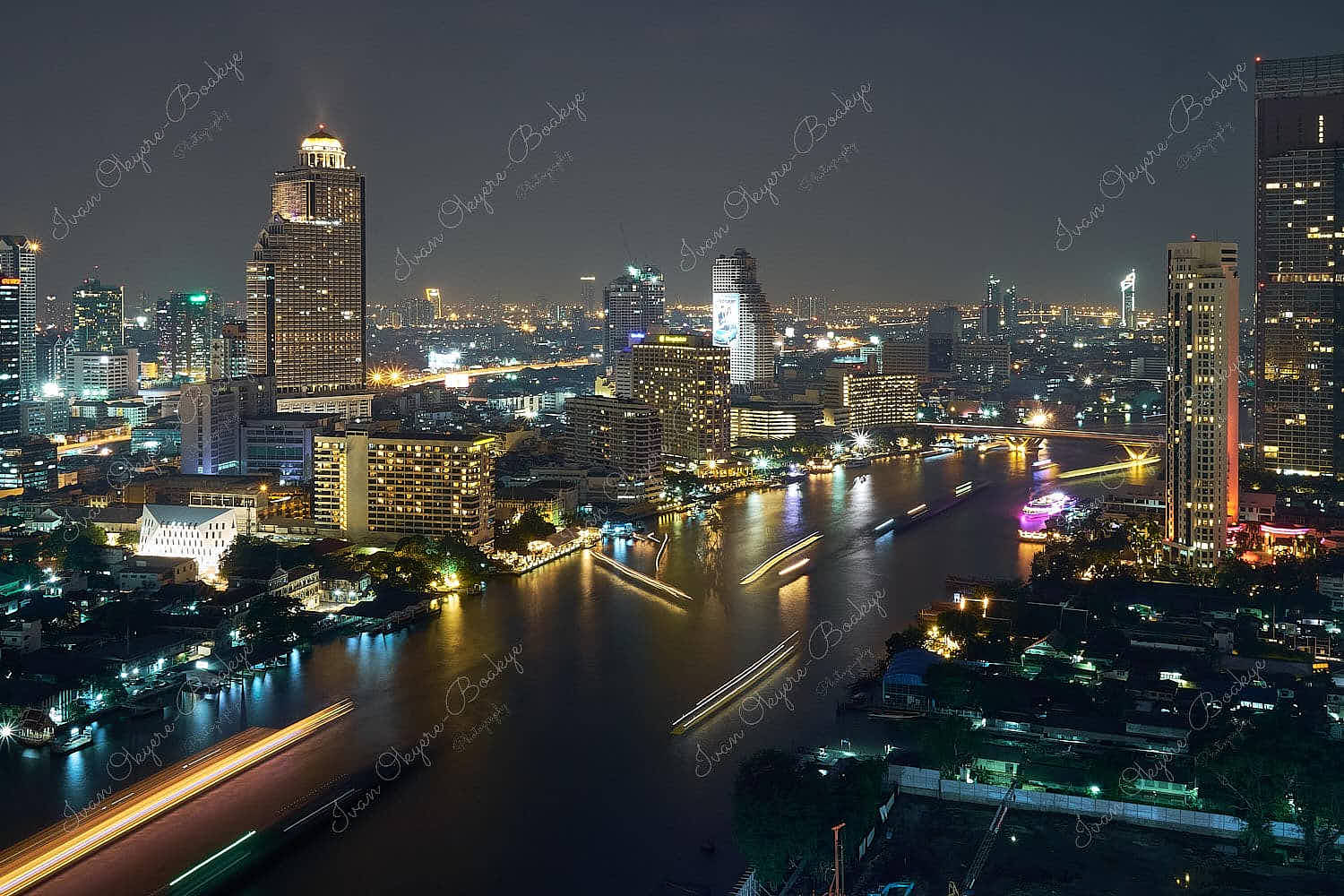 Panoramic night time view of the Bangkok skyline and the Chao Phraya river, Bangkok, Thailand