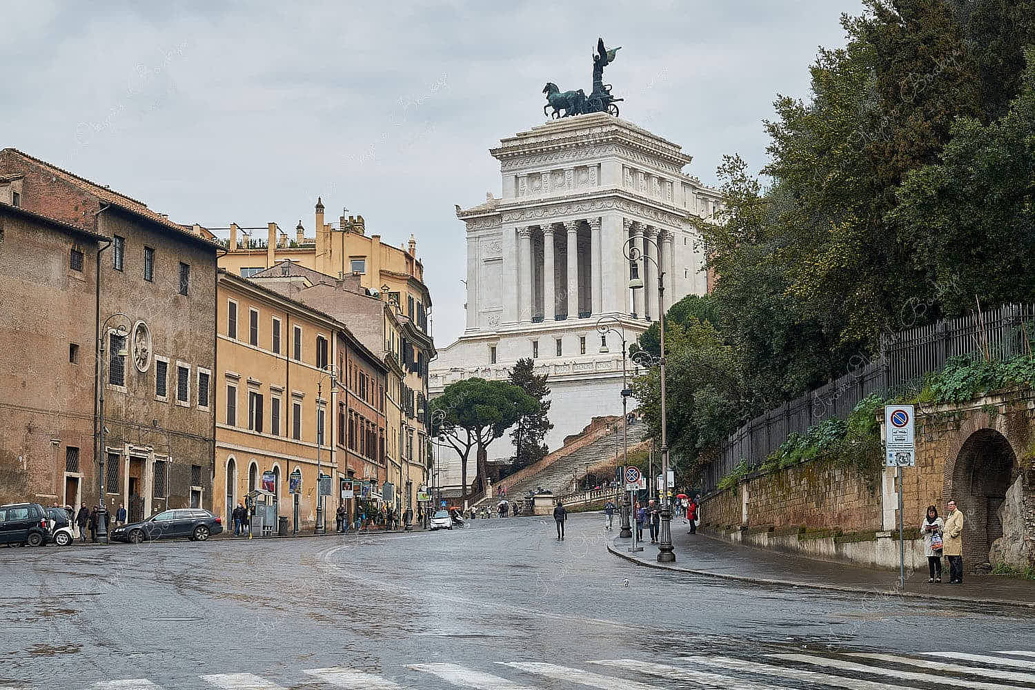 A wet Rome street scene with the glorious Museo Nazionale dell’Emigrazione Italiana in the background, Rome, Italy