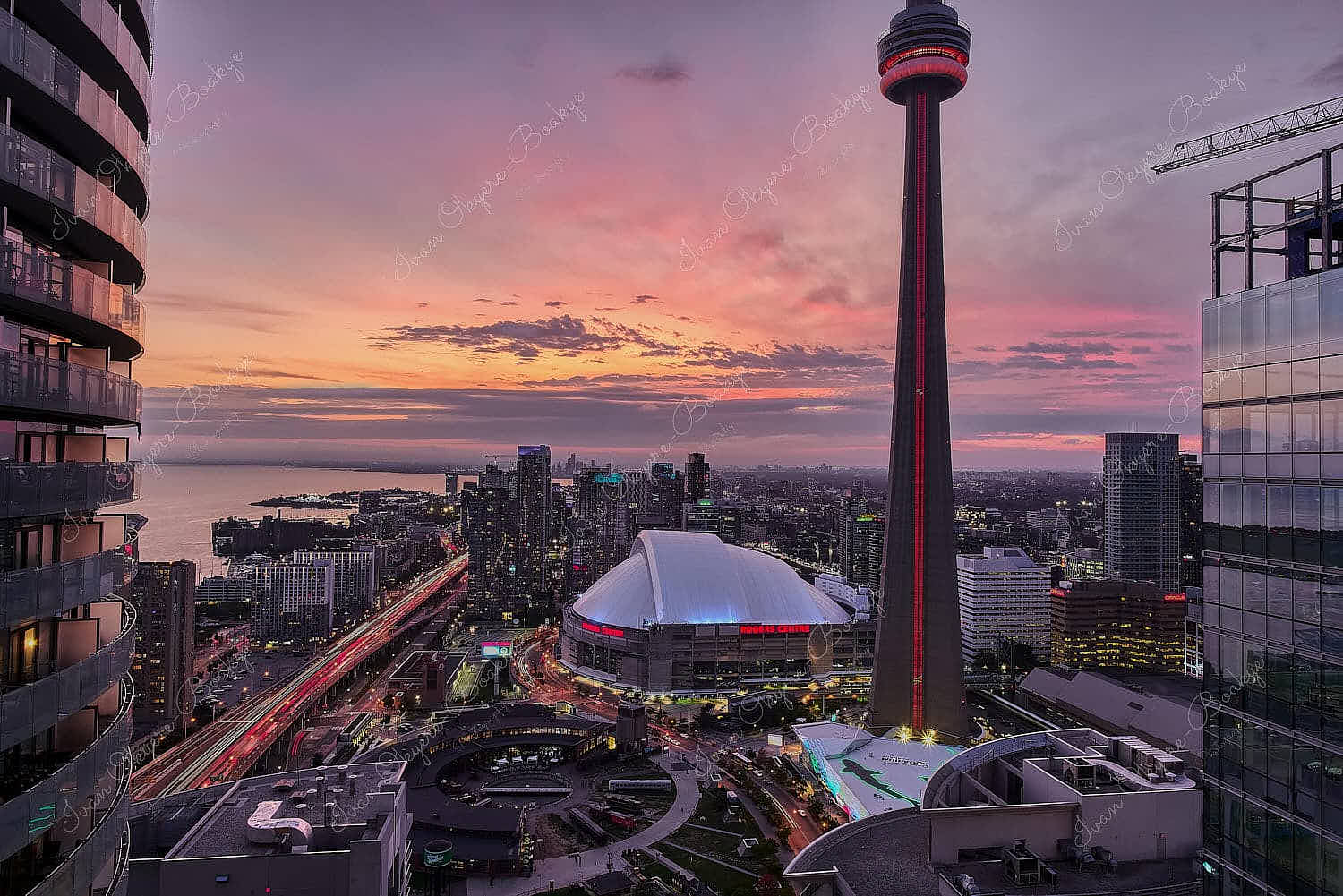 Panoramic view of the CN Tower, Ripley's Aquarium and the Rogers Centre at sunset, Toronto, Canada