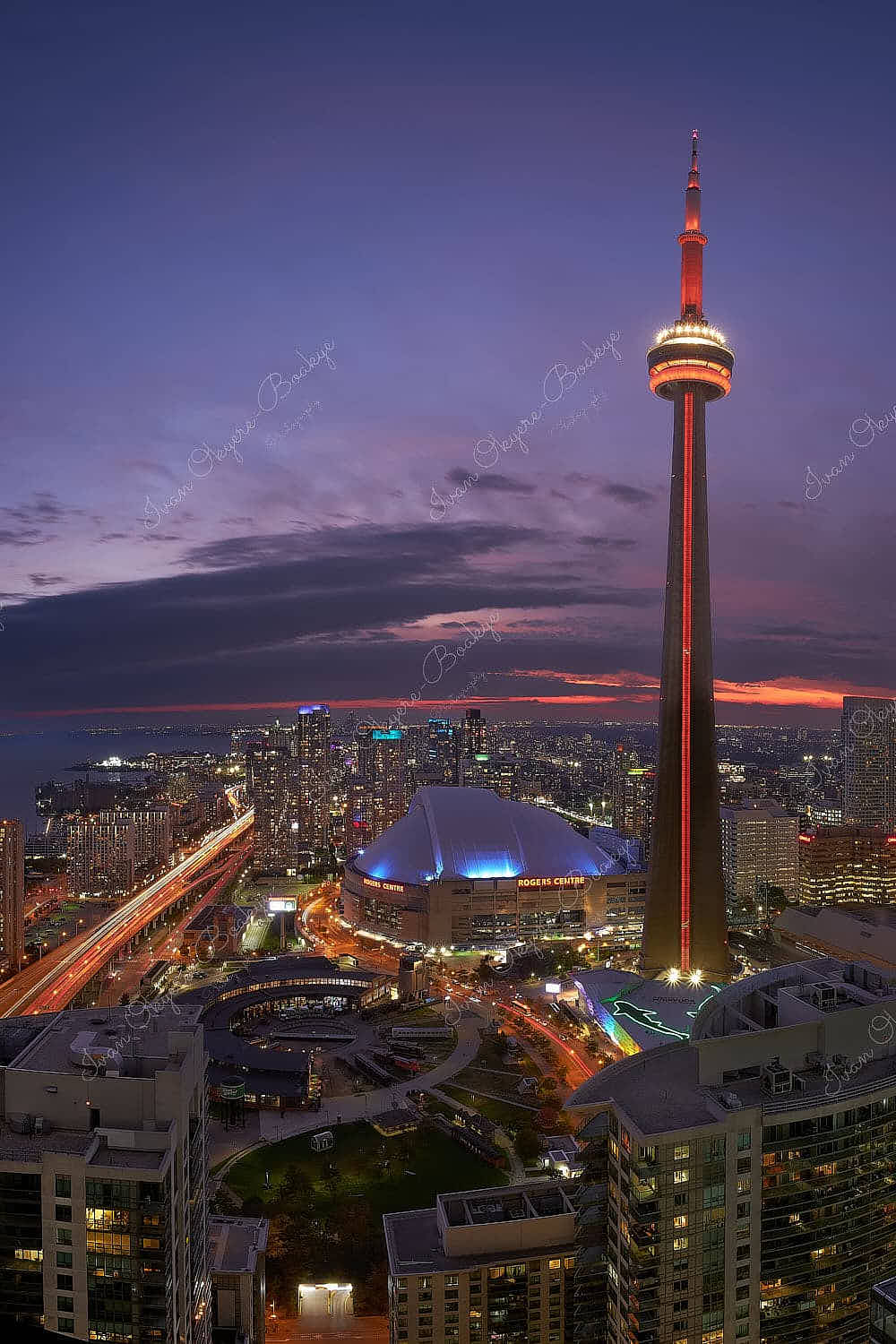 Panoramic view of the CN Tower, Ripley’s Aquarium and the Rogers Centre at sunset, Toronto, Canada
