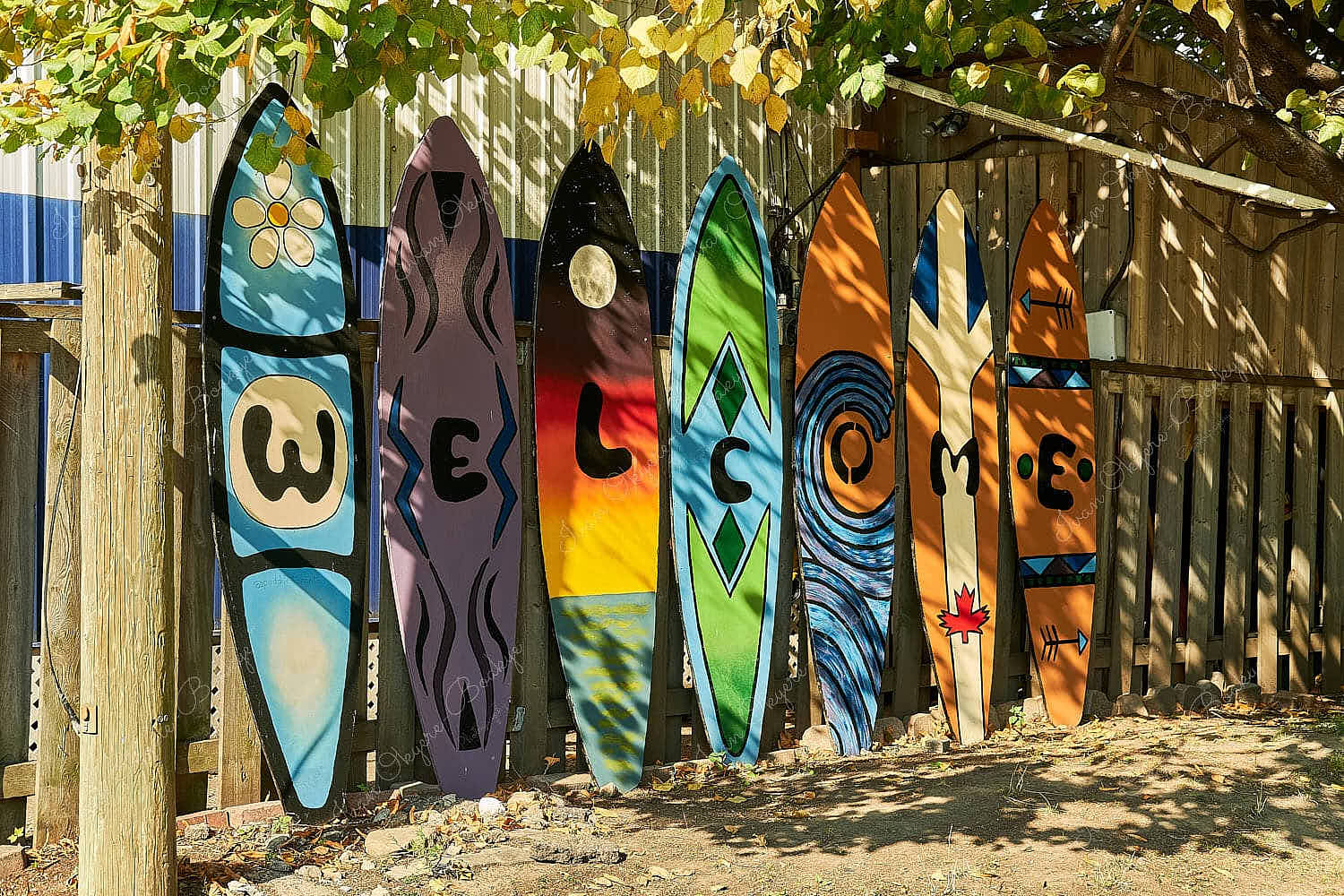 A line of colourful surf boards spelling out welcome in Toronto, Canada