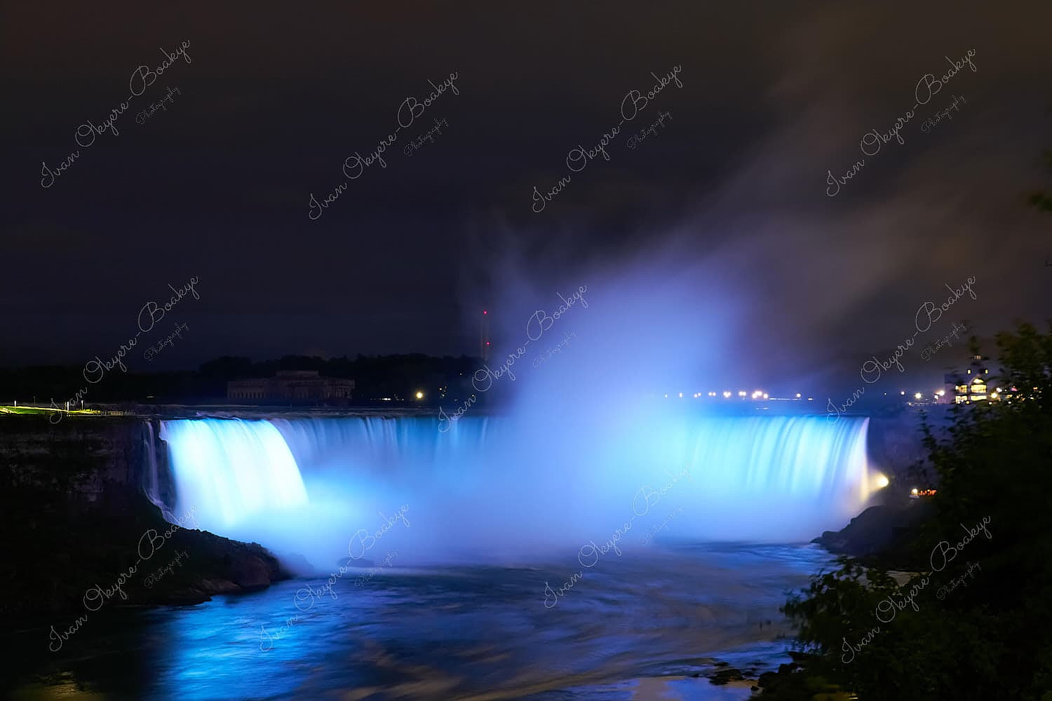 An illuminated Horseshoe Falls at night in Niagara Falls, Ontario, Canada