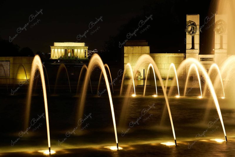 Night view of Lincoln Memorial through the illuminated Central Fountain of the World War II Memorial, Washington, America