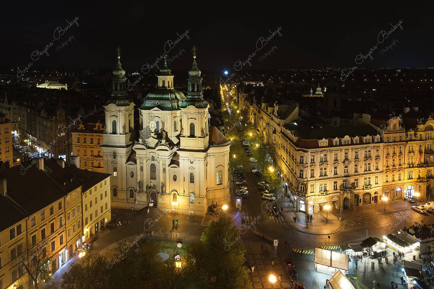 Panoramic night time view of the grand St. Nicholas Church in the Old Town Square in Prague, Czech Republic
