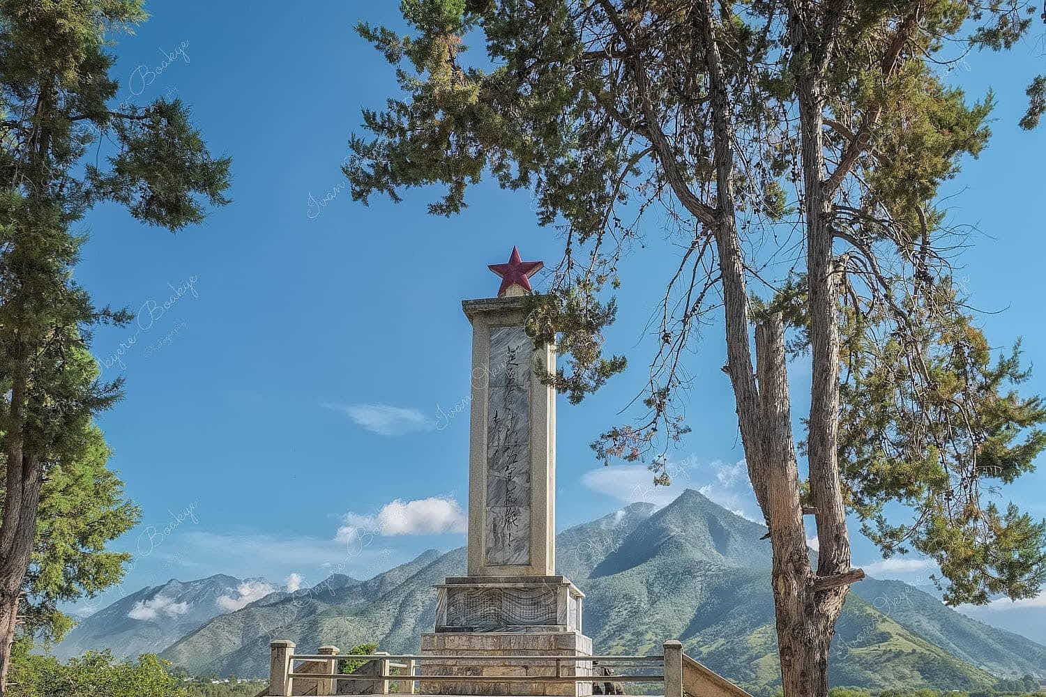 Long March Memorial Monument with red star at top with mountains as backdrop in Shangri-La, China