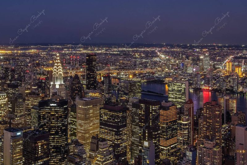 Panorama of Manhattan skyline at night with an illuminated Chrysler Building in New York, America