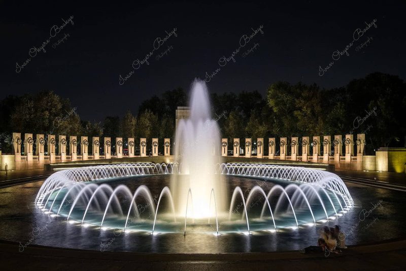 Long exposure at night of illuminated fountain at World War II Memorial, Washington, USA