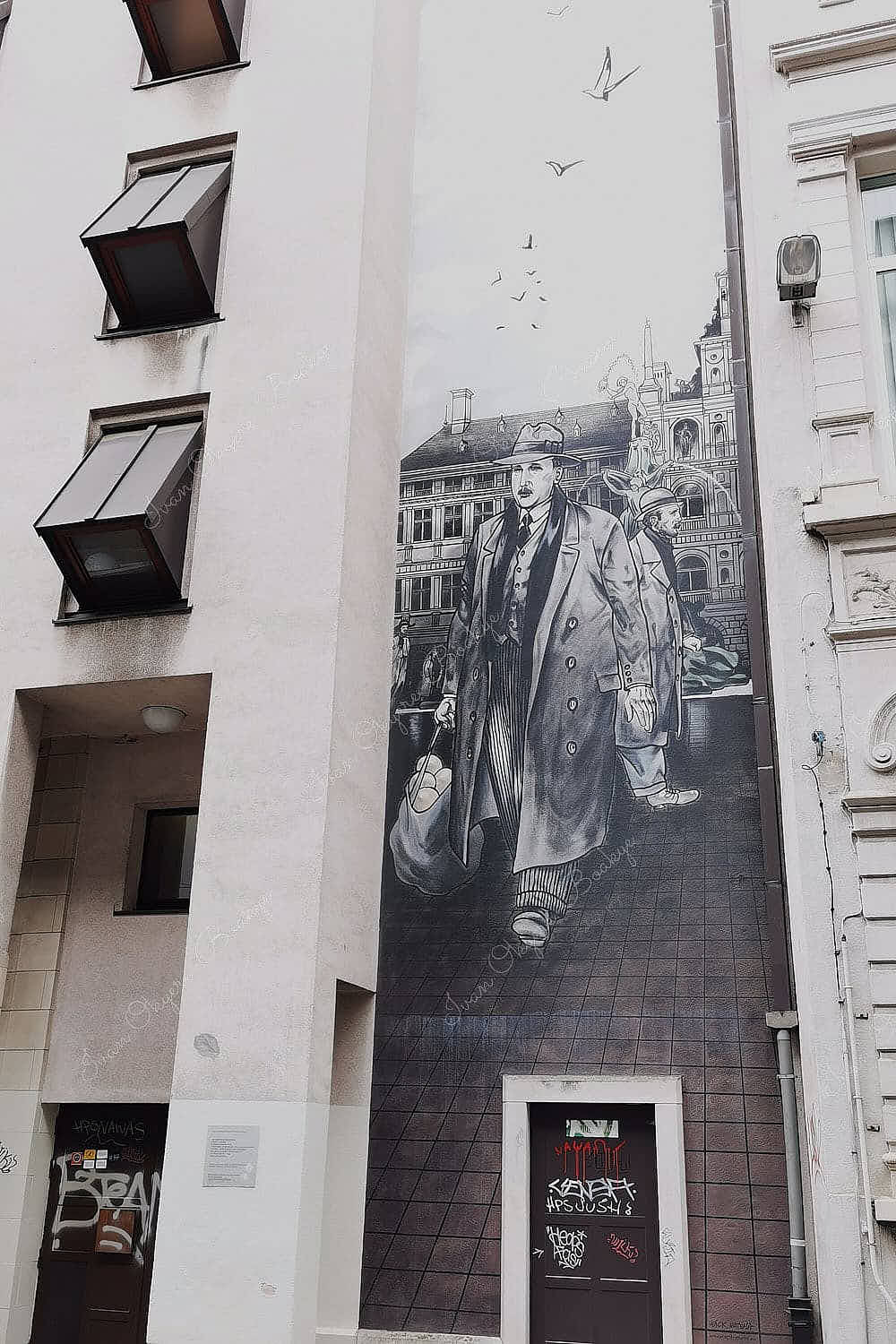 Street mural of the Dick Matena Laarmans character on the side of an apartment building in Antwerp, Belgium