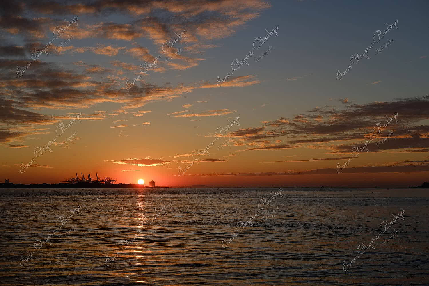 Sun setting over the horizon from the seafront at Tamsui, Taiwan